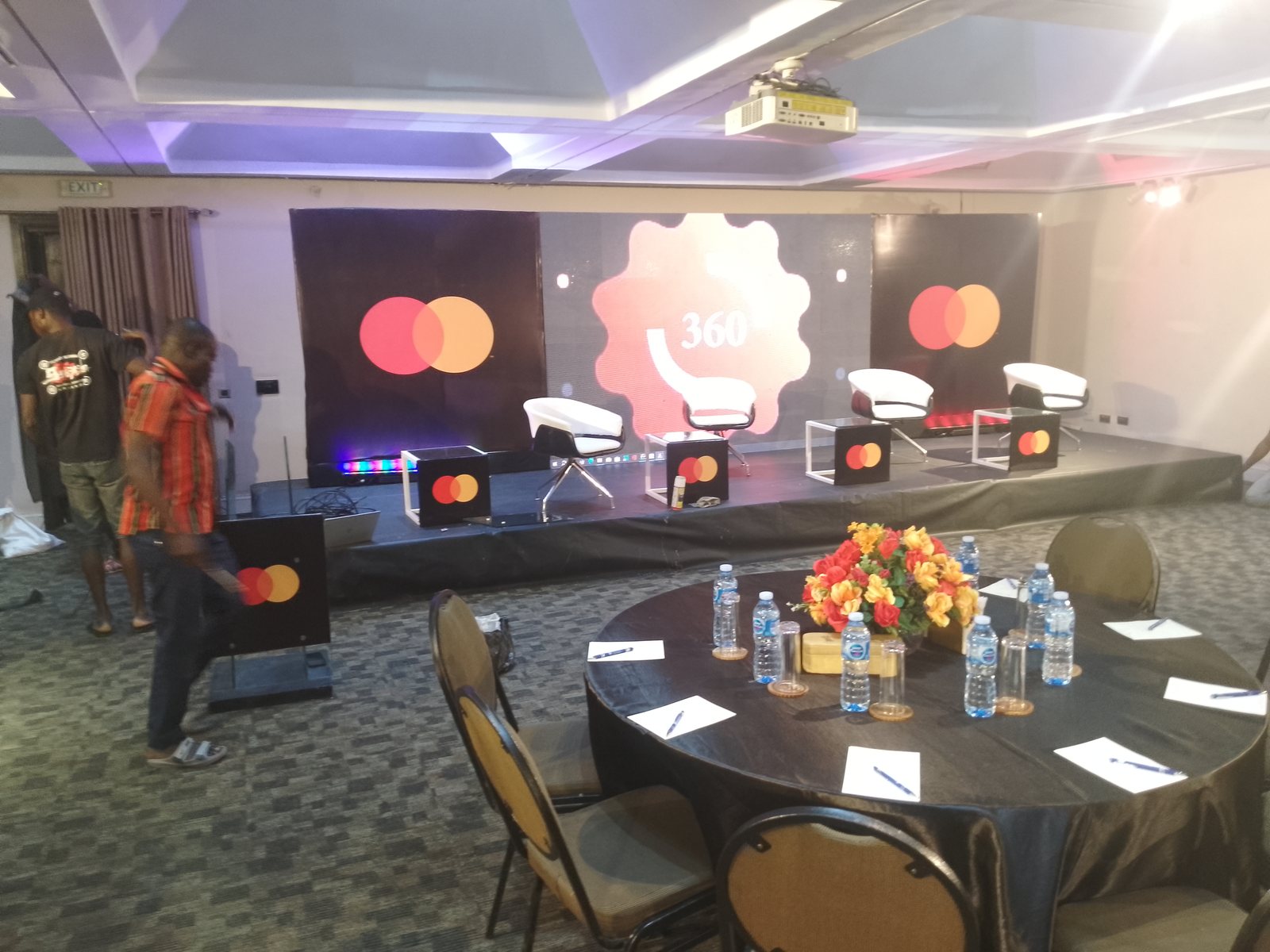 Conference stage setup with Mastercard branding
